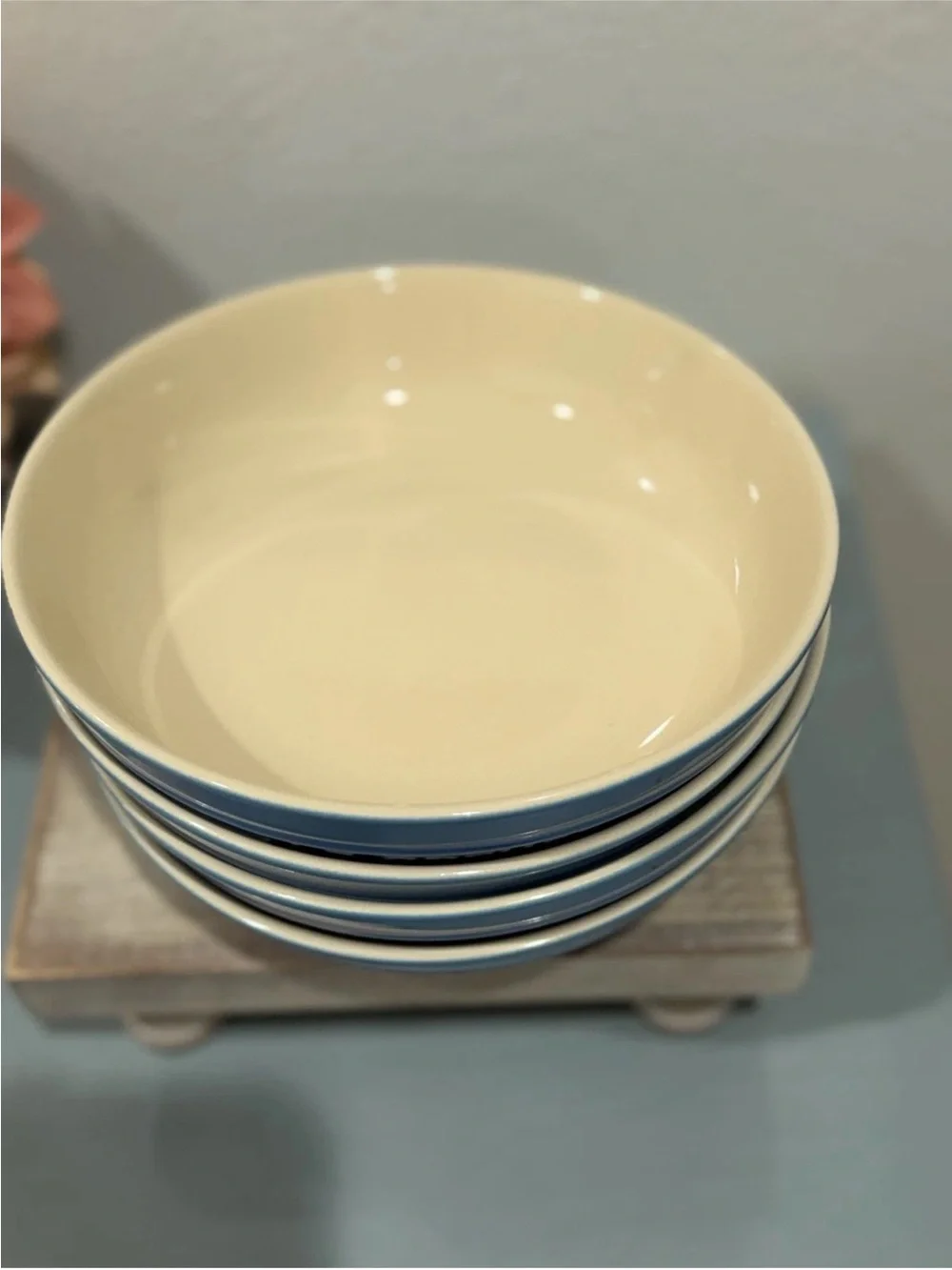 The product is a set of 4 Le Creuset deep round dish plates in a striking azure